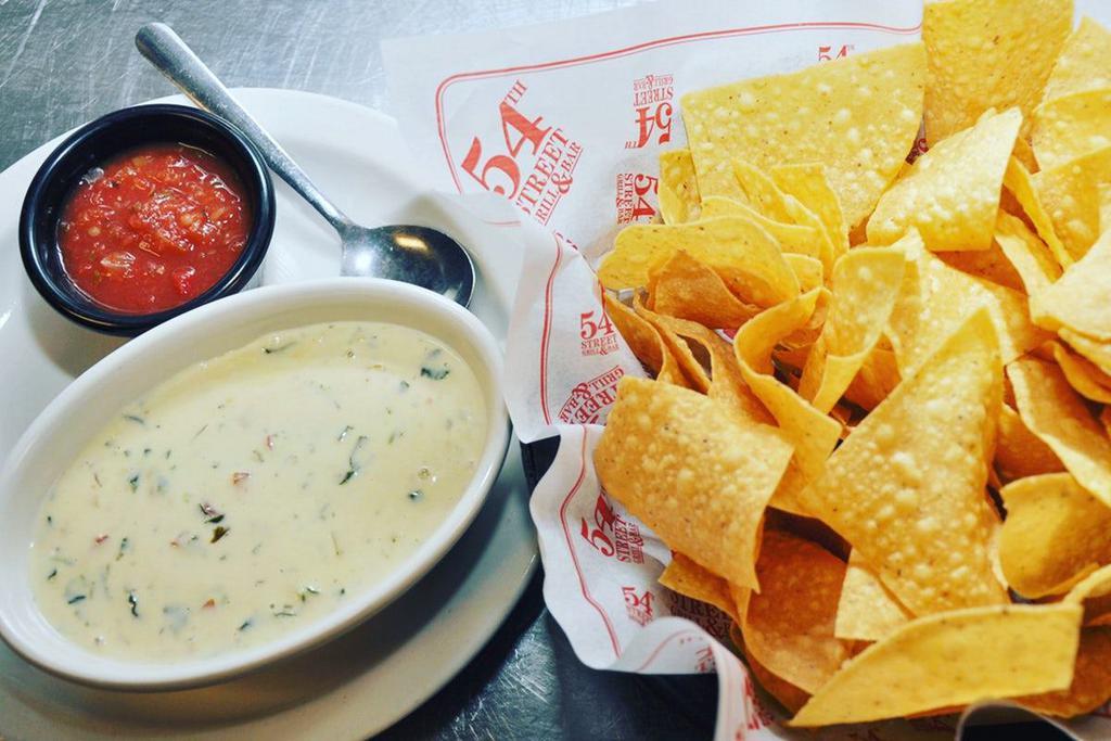 Gringo Dip® - Family Size · 24 ounces of five four’s famous house recipe, a creamy pepper jack cheese dip blended with pico de gallo and secret spices. Served with chips.