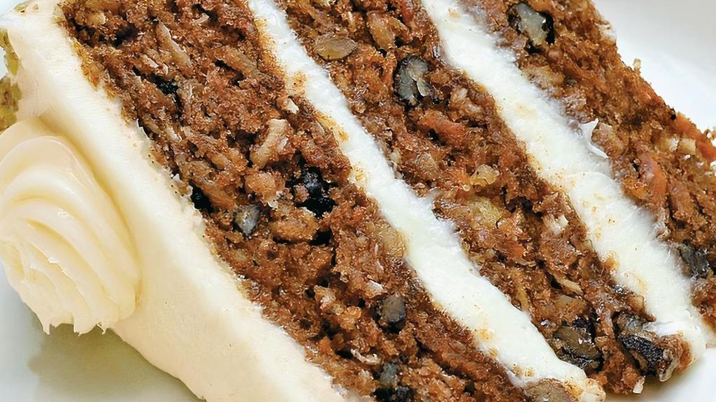 Colossal Carrot Cake · traditionally spiced, grated carrot, pineapple, walnut, pistachio, shaved coconut, real cream. cheese icing