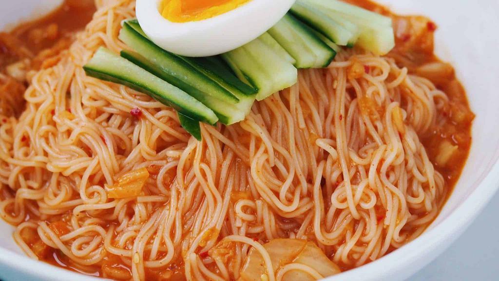 Bibim Goksu · Cold wheat noodles in spicy kimchi mixture topped with cucumbers and boiled egg