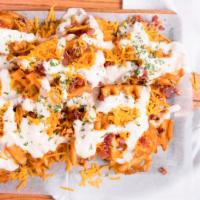 Bacon Cheddar Ranch Fries · French fries with bacon melted Cheddar cheese and topped with ranch dressing.