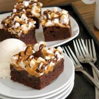Supreme Brownie Bites (Dinner Made Easier 48 Bites) · A brownie cut into 4 bite sized pieces, covered with marshmallows and drizzled with caramel ...