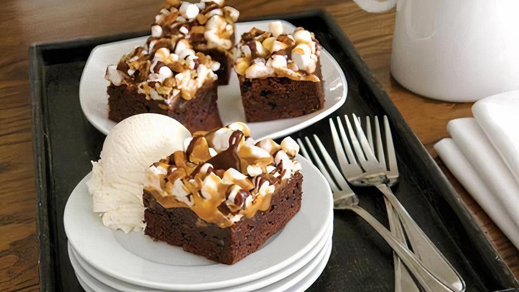 Supreme Brownie Bites (Regular) · A brownie cut into 4 bite sized pieces, covered with marshmallows and drizzled with caramel and chocolate sauce.