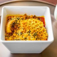Egusi Soup · Finely grounded melon seeds with freshly cut spinach, meat, dried fish, cooked in a blend of...