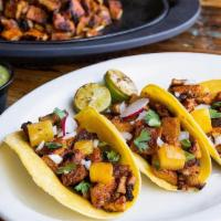 Tacos Al Pastor · Build your own tacos - served with avocado salsa, grilled pineapple, fresh cilantro, onion, ...