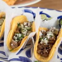 Ribeye Street Tacos · (3) Tacos; ribeye tips, onion, cilantro, soft corn tortillas -- spicy red salsa & avocado sa...