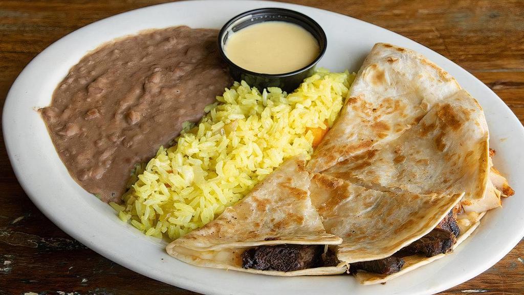 Kid Quesadillas · Flour tortillas stuffed with melted cheese served with refritos & Mexican rice. *With meat at additional cost.