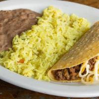 Kid Taco · Ground beef and cheese taco served with refritos & Mexican rice.