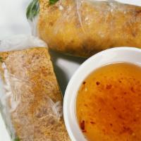Tofu Spring Rolls · Tofu rice wrapped spring rolls with light veggies on a bed of noodles. Includes a dipping fi...