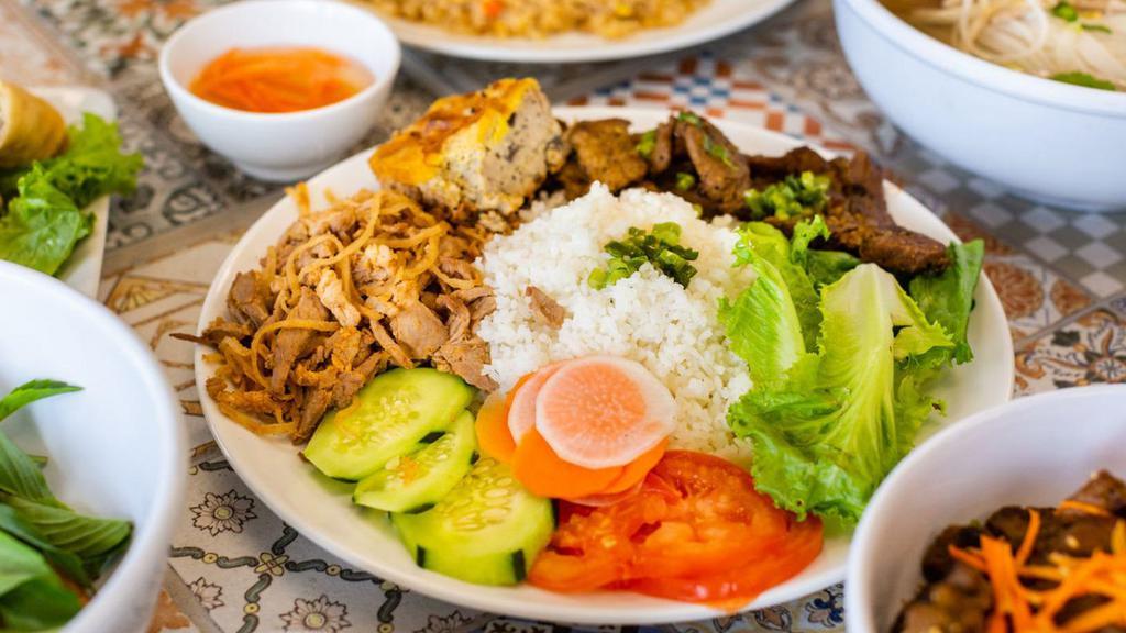 Cơm Bì Thịt Nướng Chả Trứng · Steamed rice with sliced pork, pork skin and egg meat loaf with pork.
