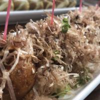 Takoyaki · Battered octopus rolled into a ball, covered with bonito and green onion, drizzled with spic...
