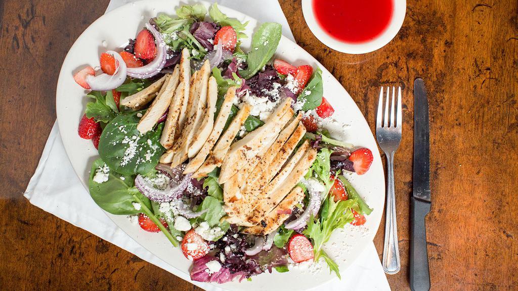 Strawberry Chicken Salad · Fresh mixed greens, fresh strawberries, red onion, Feta cheese, and grilled chicken breast topped with raspberry vinaigrette dressing.