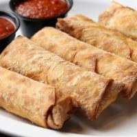 Pizza Logs · 3 pizza logs served with a side of marinara and a drink.
