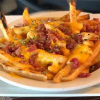 Loaded Fries · A generous portion of our fries smothered in melted cheese and topped with crispy bacon and ...