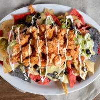 Buffalo Chicken Nachos · Tri-color tortilla chips loaded with diced chicken tossed in anchor bar wing sauce, queso, t...
