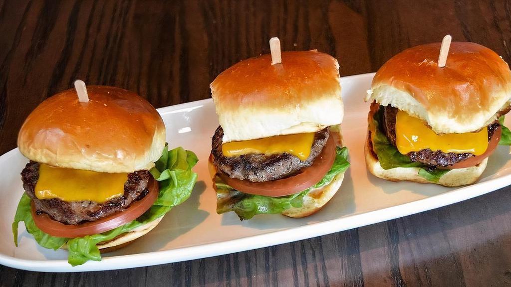 Sliders Grilled Burger · Three burger patties grilled with TL seasoning and prepared medium well. Served on toasted slider buns with melted cheddar cheese, burger sauce, red leaf lettuce, sliced tomato and pickle chips.