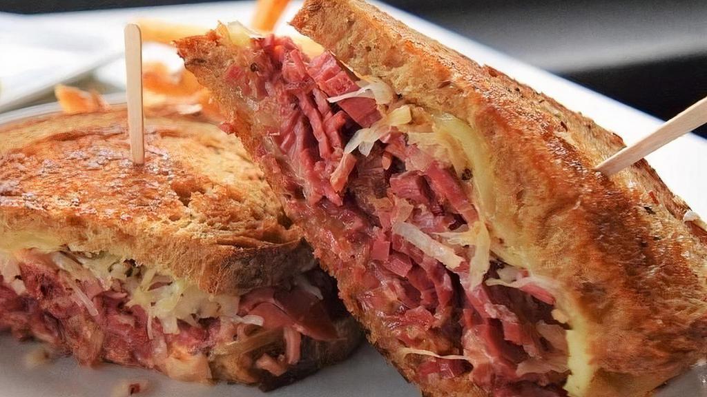 Classic Reuben · Traditional Reuben piled high with corned beef, peppered sauerkraut, melted Swiss cheese and thousand island dressing on toasted rustic rye.