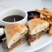 French Dip Sandwich · Slow roasted, thinly sliced beef tip topped with melted provolone cheese piled high on a Par...