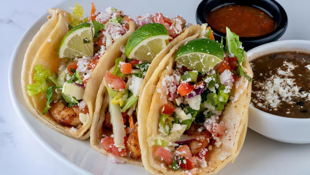 Baja Fish Tacos - Cod · Double stacked warm corn tortillas spread with chipotle aioli and layered with seasoned cod, Napa slaw tossed in Honey Lime Vinaigrette, pico de gallo and cotija cheese. Served with a side of Santa Fe black beans and a side of roasted Tomatillo salsa.