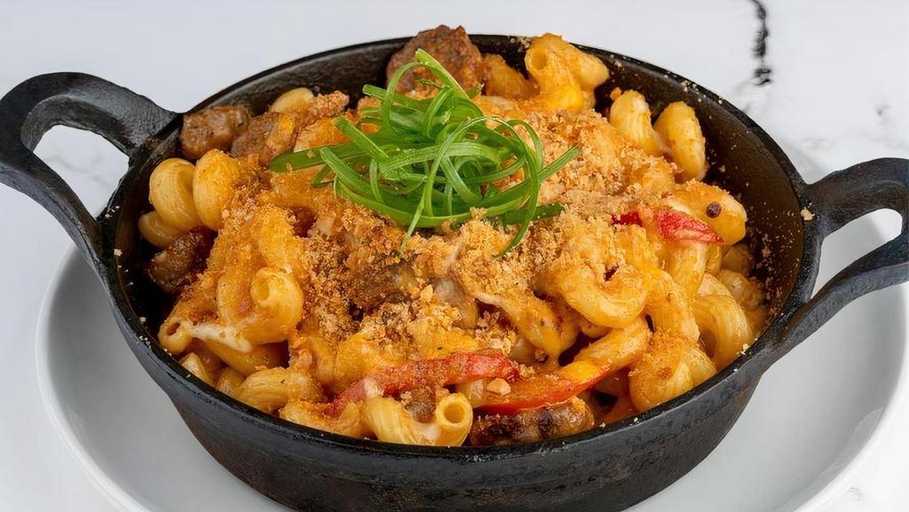 Spicy Sausage Mac And Cheese · Cavatappi pasta sautéed with Parmesan cream sauce, spicy Italian sausage, red pepper, Swiss, and cheddar & jack cheeses. Topped with breadcrumbs and baked till golden brown.