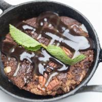 Deep Dish Chocolate Brownie · Baked with chocolate and toasted pecans.  Topped with chocolate fudge and caramel sauces.
