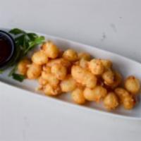 Cheese Curds · Crispy fried cheese curds, coated in tempura beer batter. Served with sweet jalapeño jam and...