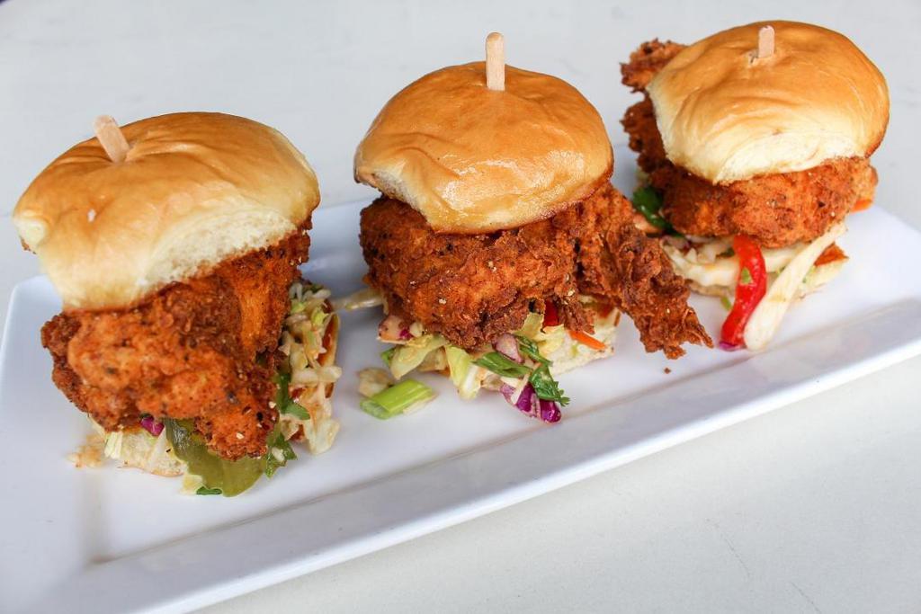 Spicy Fried Chicken Sandies · Tender chicken marinated jalapeño & buttermilk, dusted in spicy flour and crispy fried.Topped with Chipotle Slaw and dill pickles on a toasted brioche bun . 3 ea.