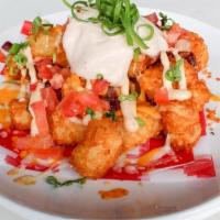Loaded Tater Tots. · Cheddar & jack cheeses, bacon, diced tomato, green onions, chipotle sour cream.
