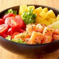 Salmon Lover Poke Bowl · A bed of sushi rice filled with marinated salmon, green leaf lettuce, mango, cherry tomato, ...