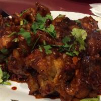 Gobi Manchurian (Dry) · Fried cauliflower fritters tossed with soy sauce based gravy cooked to the chefs perfection.