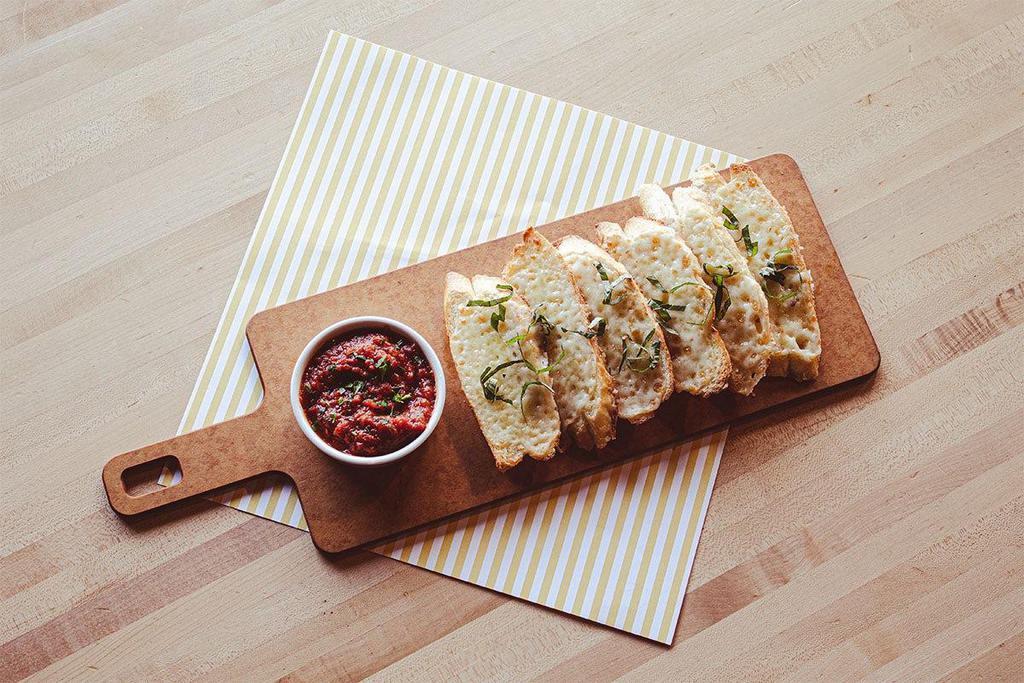 Mozzarella Garlic Bread · Probably better get two orders, it’s that good…Toasted French baguette slices covered in mozzarella, topped with fresh basil and served with a side of marinara.