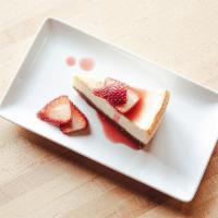 Nonna'S Cheesecake · Creamy cheesecake on a graham cracker crust. Finished with fresh strawberries, drizzled with...