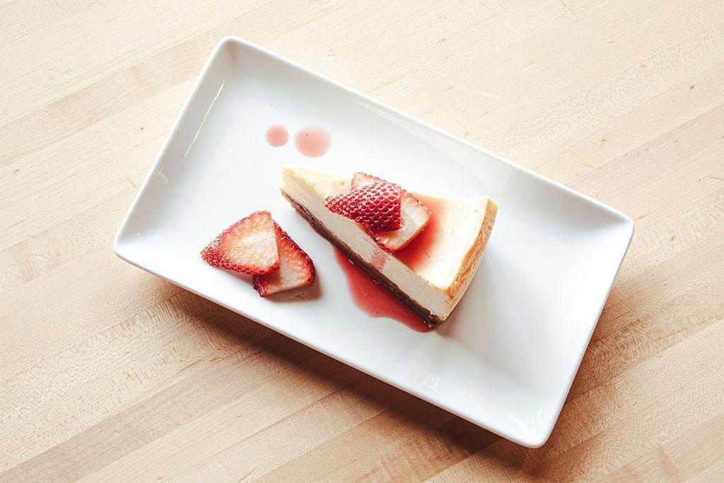 Nonna'S Cheesecake · Creamy cheesecake on a graham cracker crust. Finished with fresh strawberries, drizzled with strawberry sauce. Deliziosa!