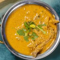 Madras Chicken Curry · Fairly hot curry with a dark red thick sauce.