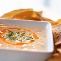 Shiner Bock Queso Blanco · White American, Smoked Gouda, Jalapeños, Tomatoes and Cilantro,
Served with White Corn Torti...