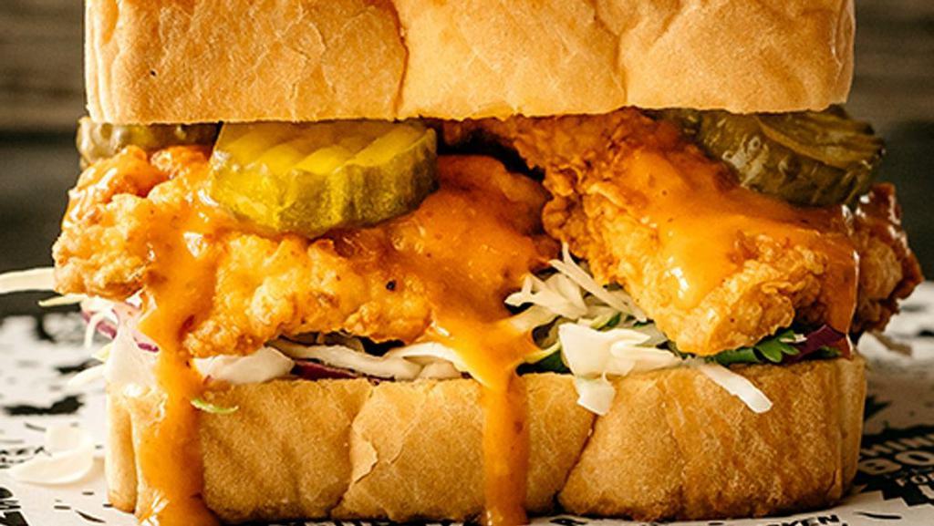 Spicy Rooster Sandwich · Two Texas sized tenders, housemade jalapeño coleslaw, jumbo sweet pickles, drizzled with our signature Cajun fire sauce, and served on Texas Toast. This sandwich bites back!