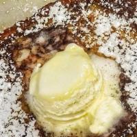 French Toast · Three pieces of sourdough French toast grilled golden brown and dusted with powdered sugar. ...