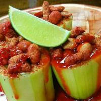 Cacahuates Barrilitos · Cucumber barrels filled with Japanese peanuts, chamoy, spices, and lime.