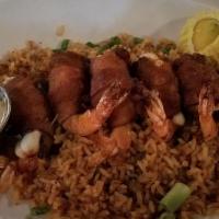 Shrimp Brochette · Bacon wrapped shrimp stuffed with serrano peppers and panela cheese served with dirty rice.