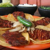 Tacos De Trompo · Five seasoned beef taquitos in corn tortillas.
Cinco taquitos de trompo en tortillas de maiz.