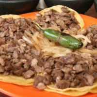 Tacos De Bistec · Five bistec taquitos in corn tortillas.
Cinco taquitos de bistec en tortillas de maiz.
