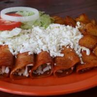 Enchiladas · Five corn tortillas in red pepper, stuffed with cheese or shredded chicken, topped with fres...