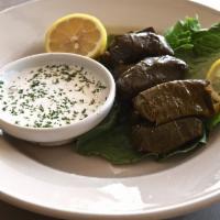 Dolmas · 1/2-dozen grape leaves stuffed with rice. Cooked in lemon juice and olive oil. Served with t...