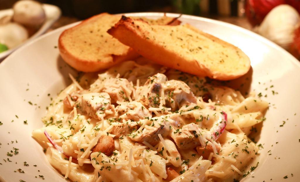 Chicken Alfredo Penne · Penne pasta, grilled chicken, roasted-smoked garlic and grilled onions in Alfredo sauce. Gluten-free option available.