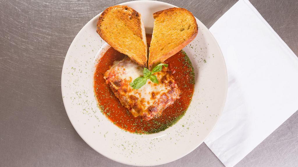 Homemade Beef Lasagna · Layers of meat stuffed pasta with mozzarella, served with with taosted garlic bread.