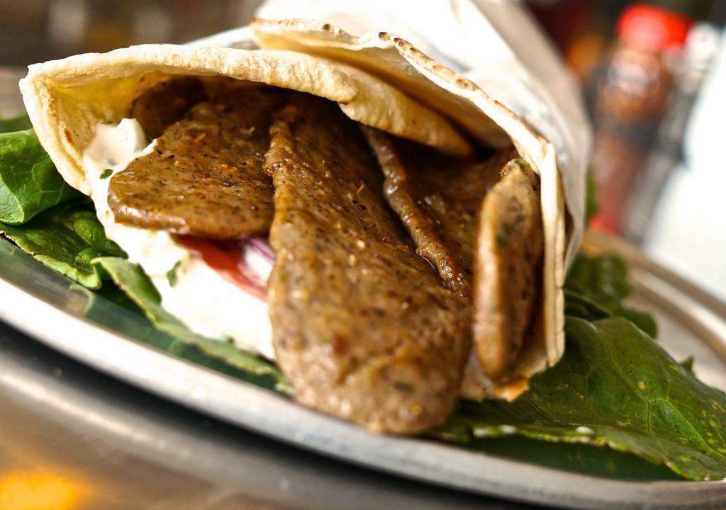 Greek Gyro · Strips of beef, tzatziki sauce, tomatoes and onions in a pita wrap. Add feta cheese for an additional charge.