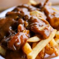 Traditional Poutine · Vegetarian. French fries topped with country brown gravy and melting Wisconsin cheese curds.