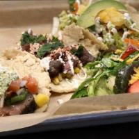 Taco Trio · A skirt taco, grilled fish, and a pork belly taco
with your choice of salad, grilled veggies...