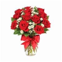 Dozen Rose Elegance · Comes with 12 red roses in a vase with a red ribbon.