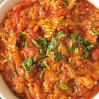 Baigan Bharta · Fire roasted eggplant mash, cooked with spices.
