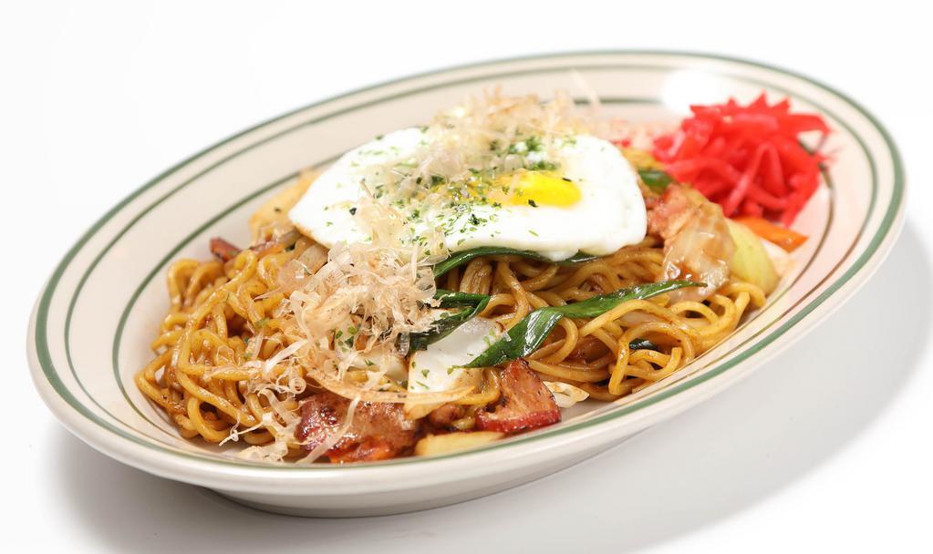 Yaki Soba · Stir-fried soba noodles with mixed vegetables, pork bacon, with pan-fried egg and bonito flakes on top.
